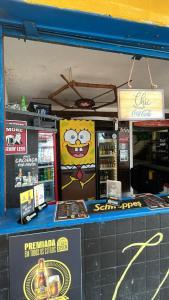 a counter in a store with a cartoon character on it at Hostel Ave Rara in Praia do Frances