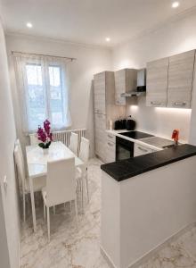 a kitchen and dining room with a table and chairs at sunset suite con terrazza e barbecue in Imperia