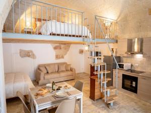 a small apartment with a loft bed and a dining room at Casa Tino - Retreat by the Sea and History in Polignano a Mare +14 photos