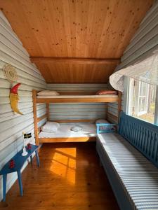 a room with two bunk beds in a cabin at Byron in Rälla