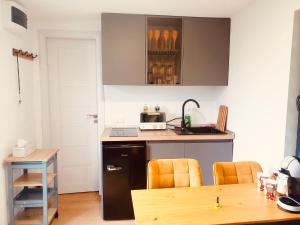 a kitchen with a counter and a table with chairs at Virajlux in Dâmbovicioara