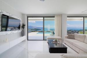 a living room with a couch and a table at Villa Eleni Di Mare in Kontokali