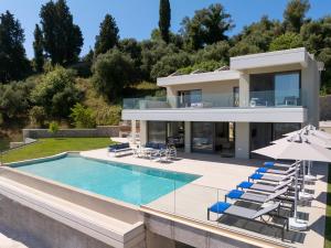 a villa with a swimming pool and a house at Villa Eleni Di Mare in Kontokali