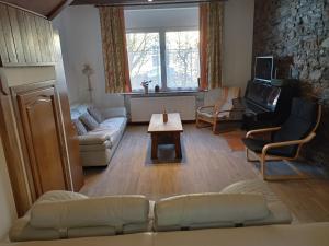 a living room with a couch and a table at Ancien relais de la diligence in Sart