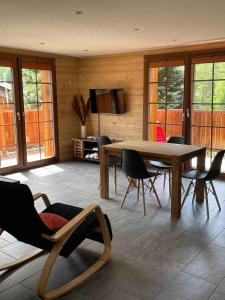 a living room with a wooden table and chairs at Sole Mountain apartement in Zermatt