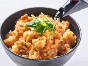 a bowl of rice with a spoon in it at Dormy Inn Hiroshima in Hiroshima