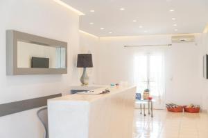 a white room with a table and a mirror at Studio in a family hotel in Perivolos
