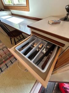 a drawer in a table with utensils in it at Byron in Rälla +23 photos