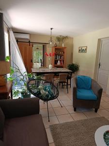 a living room with a table and chairs at Gite du riage classé 3 étoiles près d 'Anduze , Cévennes in Saint-Christol-lès-Alès