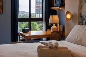 a bedroom with a bed with a teddy bear on it at Luxury Designer Studio Sealy Bed Coffee Bar Walk to Cicada Market & Beach in Hua Hin