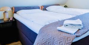 two beds with white sheets and towels on them at Haus am Skilift Postwiese in Winterberg