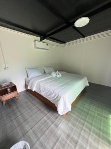 a bedroom with a bed with two towels on it at เหนือสะปัน in Ban Huai Ti +17 photos