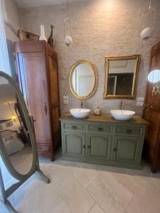 a bathroom with two sinks and a mirror at Casa Veranda sul mare in Gela +37 photos