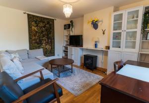 a living room with a couch and a table at Stonechat Cottage - Portmagee in Portmagee