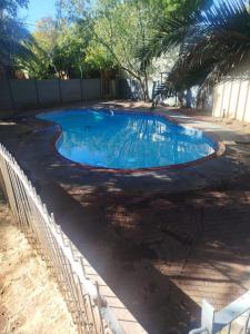 a small swimming pool with a fence around it at NAMOLEKA House- Bloemfontein in Bloemfontein