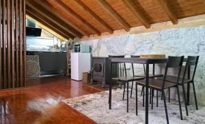 a kitchen with a table and chairs and a stove at Moose House EV Charging Pool Gated Community in Loivos