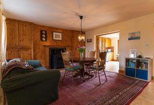 a living room with a table and chairs at Stonechat Cottage - Portmagee in Portmagee