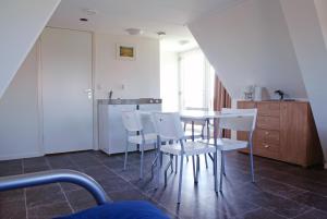 een keuken met een tafel en stoelen in een kamer bij Gouden Plakje in Gaastmeer