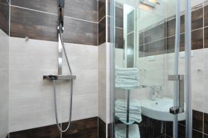 a bathroom with a shower and a sink at Old Town Square Apartments in Prague