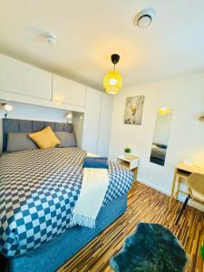 a bedroom with a bed and a table and a desk at Britlodge Ruskin Stay in Manchester