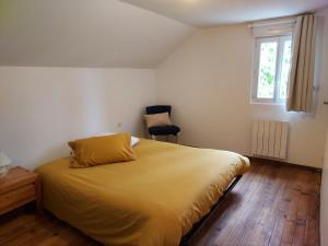 a bedroom with a bed and a window and a chair at Garde barrières N 22 in Cholet