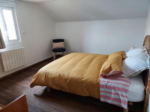 a bedroom with a bed and a chair and a window at Garde barrières N 22 in Cholet