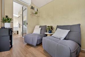 a living room with two chairs and a couch at Crown Equine Retreat in North Dandalup