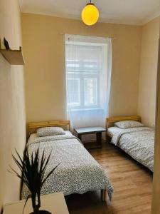 a bedroom with two beds and a window at House1890 in Kula