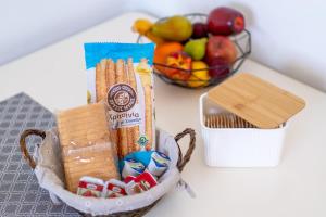 a basket of crackers and a bowl of fruit at Anthia studio in Koutsourás +4 photos