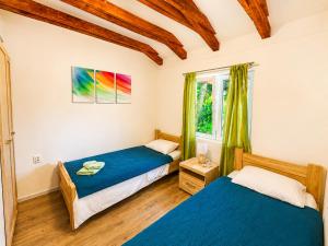 a bedroom with two beds and a window at Villa Sunset, Dobrota in Dobrota