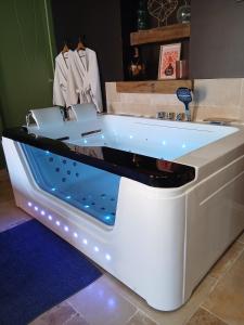 a white bath tub in a room at instant à deux in Précigné +35 photos