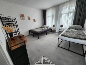 a room with two beds and a couch in it at Apartment Weserblick in Hameln