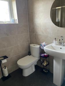 a bathroom with a toilet and a sink at Apartment 288 in Lower Swanwick