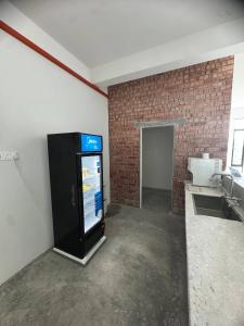 a vending machine in a room with a brick wall at Brick Box Family Hotel Ipoh in Ipoh +6 photos