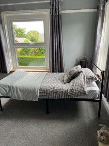 a bed in a bedroom with a window at Apartment 288 in Lower Swanwick