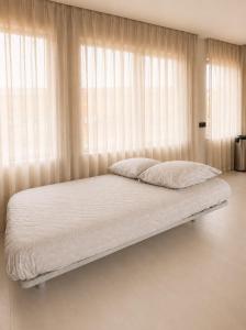 a bed in a room with a large window at Elegant Central Apartment Quiet and Bright in Brussels