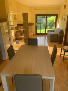 a wooden table and chairs in a living room at Roma country resort in Rome