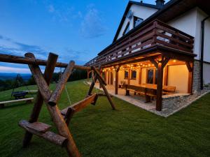 a house with a swing in front of it at Na szlaku Baraniej Góry in Istebna