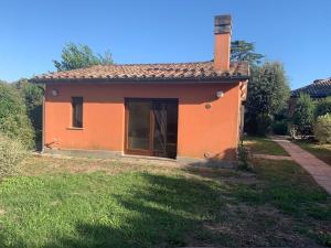 a small orange house in a field of grass at Roma country resort in Rome