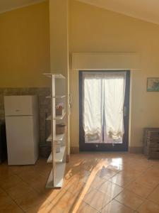 a room with a refrigerator and a door with a window at Roma country resort in Rome