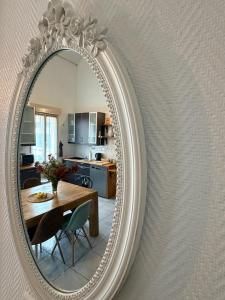 a mirror hanging on a wall in a kitchen at La Petite Maison in Montbard