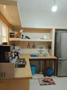a small kitchen with a stainless steel refrigerator at Maison d'hôte Najah 1 in Khenifra