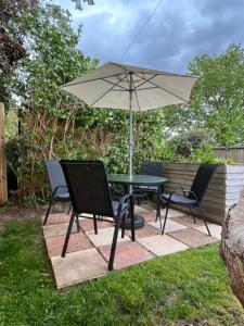 a table and two chairs and an umbrella at Apartment 288 in Lower Swanwick