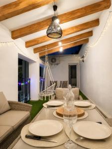 a dining room with a table with plates and wine glasses at Casa Vicen in Bolbaite