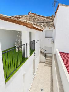 a balcony of a white building with a staircase at Casa Vicen in Bolbaite
