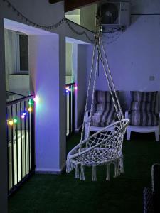 a white chair hanging from a porch with lights at Casa Vicen in Bolbaite