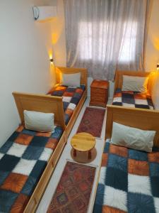 a room with three bunk beds and a window at Maison d'hôte Najah 1 in Khenifra
