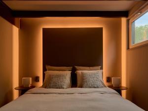 a bedroom with a large bed with two lamps at Yasu Stay Sonnevijver Rekem in Lanaken