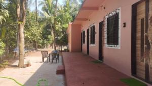 a hallway of a building with a table and a bench at Sanvi Resort Malvan in Malvan