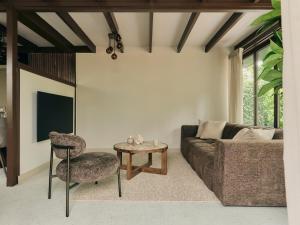 a living room with a couch and a table at Yasu Stay Sonnevijver Rekem in Lanaken